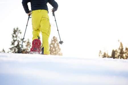 Snowshoeing in winter in deep snow. Walking in the snow. Hiking in the mountains in winter.の写真素材