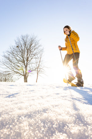 Snowshoeing in winter in deep snow. Walking in the snow. Hiking in the mountains in winter.の写真素材