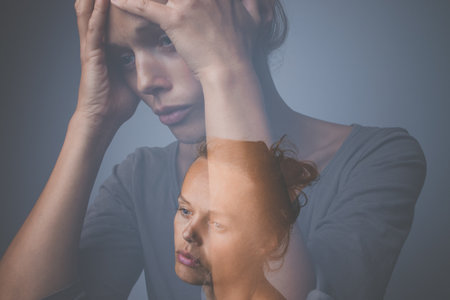Depressed, anxious young woman suffering from mental disorders, illnessの写真素材