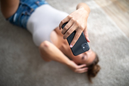 Attractive young woman taking selfies with her smartphoneの写真素材