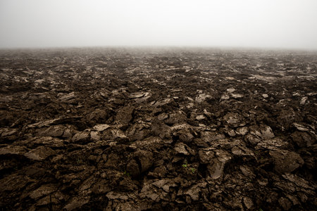 Fertile, dark soil, field after plowing. Getting ready for the next growing season being turned by plowingの写真素材