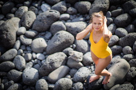 Crashing waves on rocks landscape nature view and Beautiful tropical sea with Sea coast view in summer season with a female swimmerの写真素材