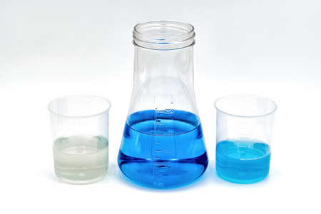 One flask with blue content, along with two laboratory beakers. Perfect for the medical field, such...
