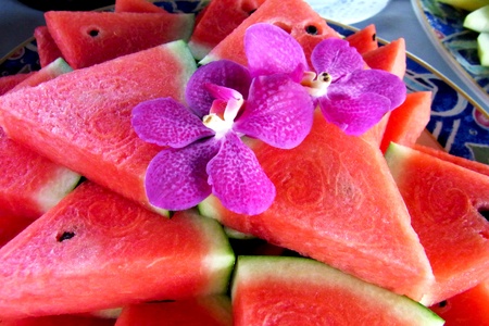 watermelon served in large ceramic tray and decorated with orchid                                        の写真素材