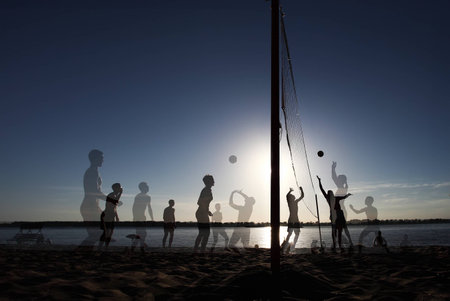 Multiexposition beach Volleyball at Sunset Enjoyment Conceptの写真素材