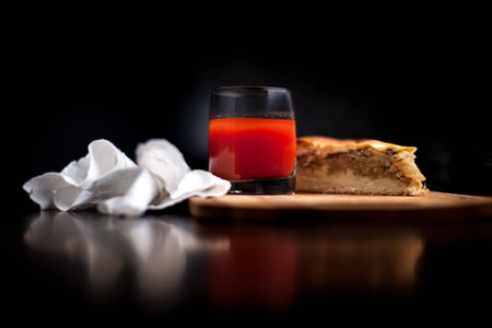 Homemade pies with potatoes. Tomato juice and potato pies lie on a wooden tableの写真素材