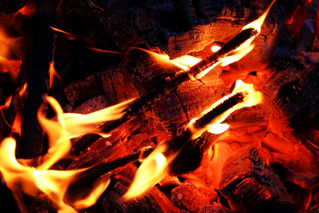 Glowing embers in hot red color, abstract background. The hot embers of burning wood log fire. Firewood burning on grill.の写真素材