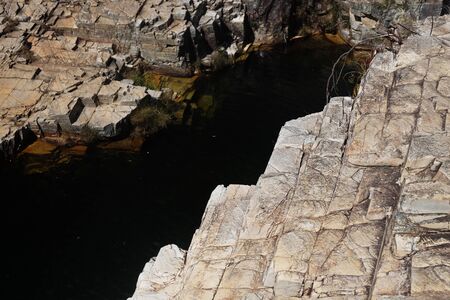 The texture of stone of the rock on a sunny day with the micro shadowsの写真素材
