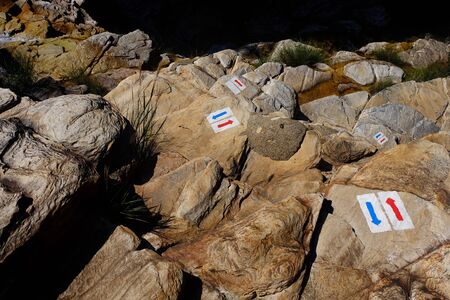 Blue and red arrows, on stones in the national park in the Brasil, shows the direction of forward and backward movement along the path.の写真素材