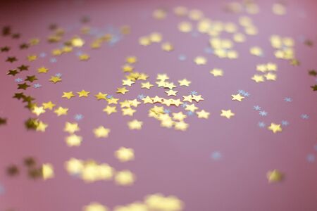 Stars and snowflakes on a pink background, from above..の写真素材