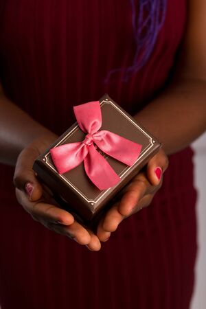 Close up view of hands are giving a beautiful gift box to you, female giving gift, presents and greeting season concept..の写真素材