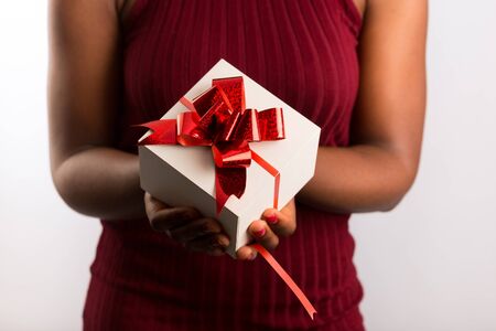 Close up view of hands are giving a beautiful gift box to you, female giving gift, presents and greeting season concept..の写真素材