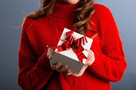 Close up view of hands are giving a beautiful gift box to you, female giving gift, presents and greeting season concept..の写真素材