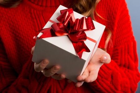 Close up view of hands are giving a beautiful gift box to you, female giving gift, presents and greeting season concept..の写真素材