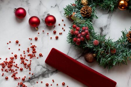 Decorated Christmas wreath with cones and beads, on a stone background..の写真素材