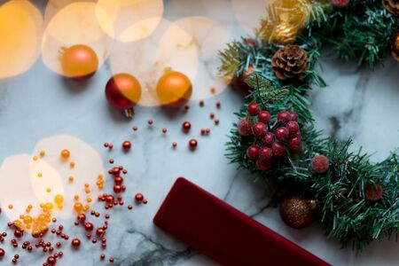 Decorated Christmas wreath with cones and beads, on a stone background..の写真素材