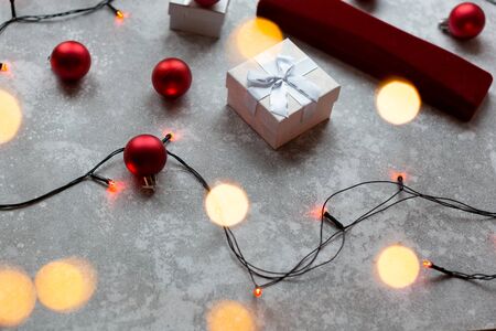 Christmas balls and white vinous gift boxes form the decoration of the Christmas tree, in the background in the form of a bokeh you can see colorful lights typical of the holiday season..の写真素材