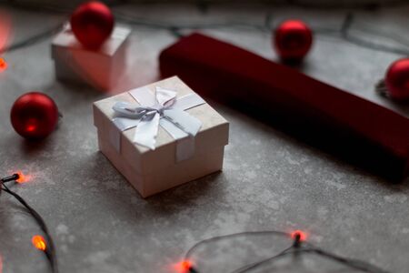 Christmas balls and white vinous gift boxes form the decoration of the Christmas tree, in the background in the form of a bokeh you can see colorful lights typical of the holiday season..の写真素材