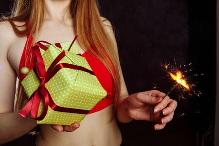 Close up view of hands and lips are giving a beautiful gift box to you, female giving gift, presents and greeting season concept on isolated gray background..の写真素材