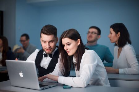 2016.01.17 Business school training in the Samara State University. Handsome couple of students use Laptop while Listening to a Lecture at the University. Multi Ethnic Group of Modern Bright Students.のeditorial素材