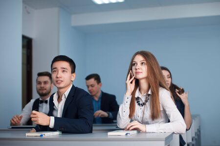 2016.01.17 Business school training in the Samara State University. Handsome couple of students use Laptop while Listening to a Lecture at the University. Multi Ethnic Group of Modern Bright Students.のeditorial素材