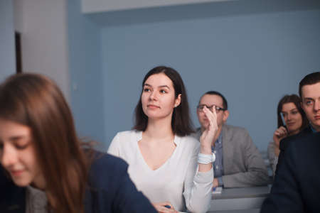 2016.01.17 Business school training in the Samara State University. Lady student is raising her hand in class for an answer.のeditorial素材