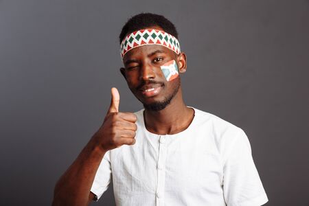 Portrait of african man from Burundi country in national clothes with thumb up
