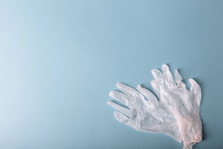 Whitte surgical gloves isolated on the blue background. Concept protect against infection or...