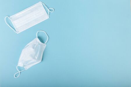 Three surgical medical masks used and unused are on an isolated background.の写真素材