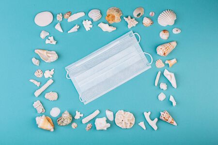 Protection mask inside Frame for photo is made from different kinds of seashells, corals. Vacation during COVID-19.の写真素材