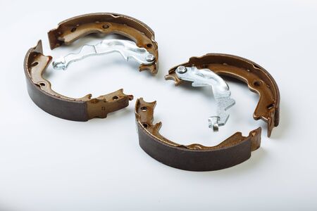 Pair of expanding internal brake shoes isolated on white background. Focus on front one.の写真素材
