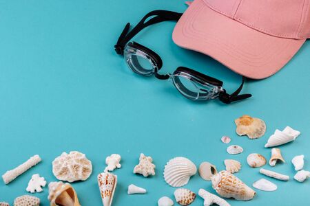 Vacation concept: cap, swimming goggles, different kinds of seashells, corals.の写真素材