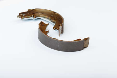 Hand brake pads are lying on the white surface before replacement operationの写真素材
