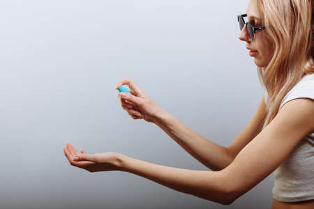 Closeup of pretty womans hand doing press spray alcohol for sterilize virusの写真素材