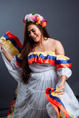 Fashion portrait of dancing pretty Colombian woman isolated on gray backgroundの写真素材