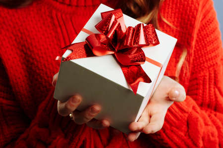 Close up view of hands are giving a beautiful gift box to you, female giving gift, presents and...