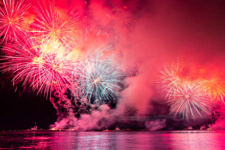 Colorful fireworks reflect from water, beautiful sceneryの写真素材