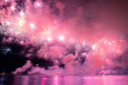 Colorful fireworks reflect from water, beautiful sceneryの写真素材