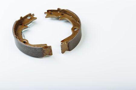 Hand brake pads are lying on the white surface before replacement operationの写真素材