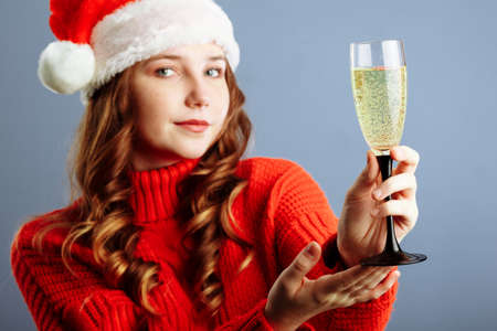 Sexy happy woman with champagne glass isolated on gray background. Selective focusの写真素材
