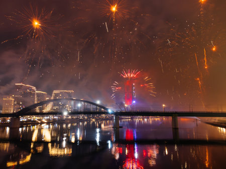 Drone flight above colorful fireworks on the black sky background over-water.の写真素材