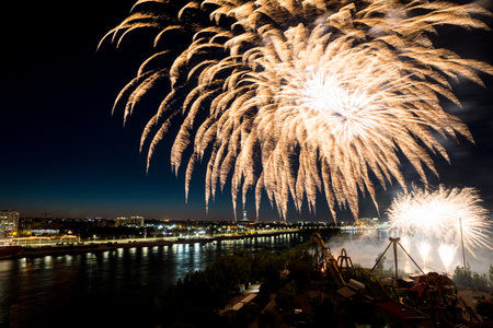 Holiday fireworks above water with reflection on the black sky background.の写真素材