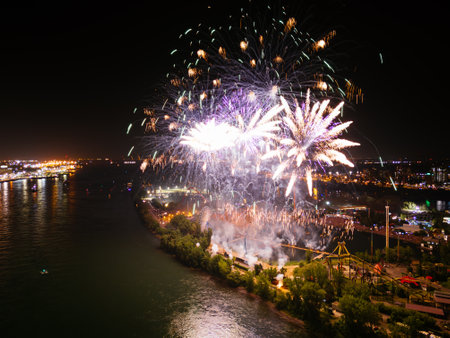 Holiday fireworks above water with reflection near to Jacques Cartier Bridge, Jean-Drapeau park....