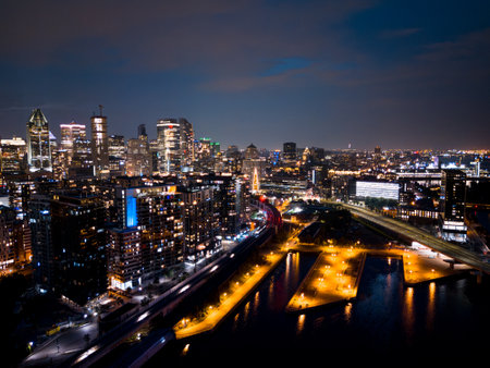 Montreal skyline illuminated at dusk and reflected in the water, Quebec, Canada.