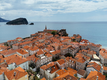 Aerial view of the Old Budva town, port, beach, and mountainsの写真素材