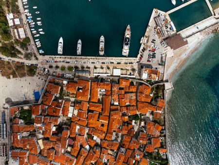 Aerial view of the Old Budva town, port, beach, and mountainsの写真素材