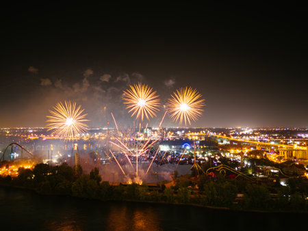 Holiday fireworks above water with reflection near to Jacques Cartier Bridge, Jean-Drapeau park. Montreal, Quebec, Canadaの写真素材
