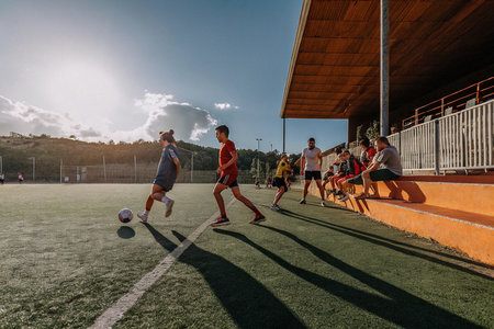 A group of people of different ages, genders, nationalities are playing soccerの写真素材