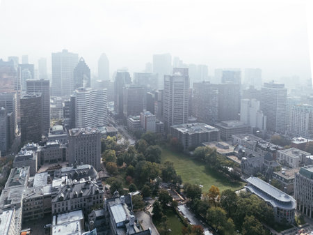 Drone flight in the downtown city skyline, foggy daytime view of Montreal, Quebec, Canadaの写真素材