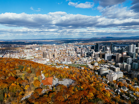 Drone flight above the autumn park with downtown skyscrapers in the background. Mont-Royal park, Montreal, Canada.の写真素材